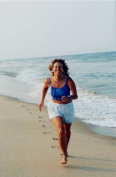 Beverley Kane running on sand along a beach